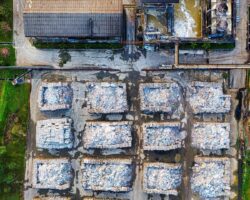 Aerial view of a recycling facility with sorted piles of construction waste