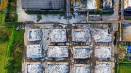 Aerial view of a recycling facility with sorted piles of construction waste